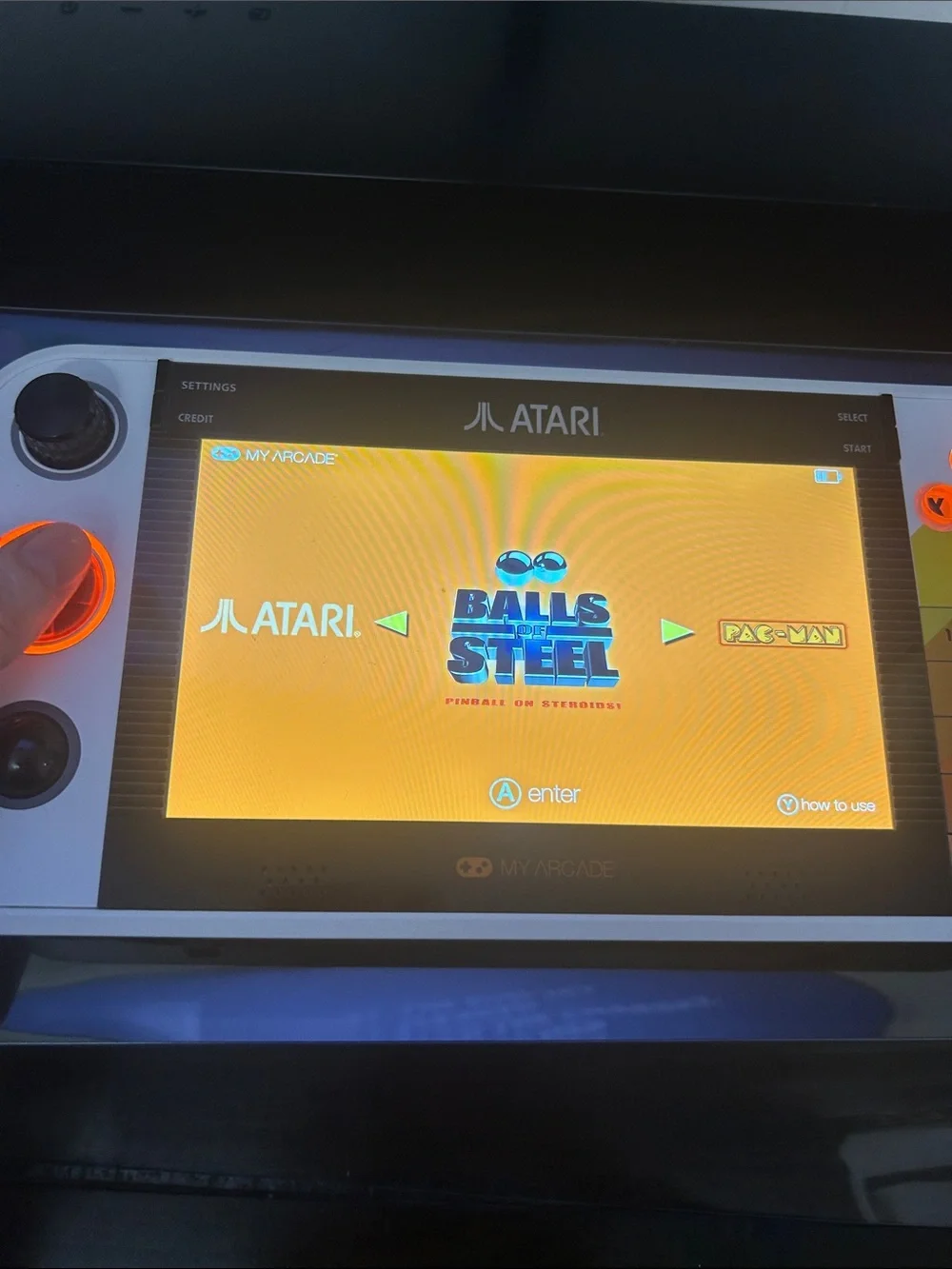 Atari Handheld Gaming Console in White and Orange